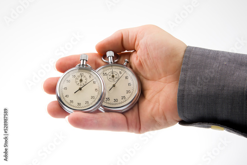 Two mechanical stopwatches in a male hand. Time part precision. Measurement of the speed interval