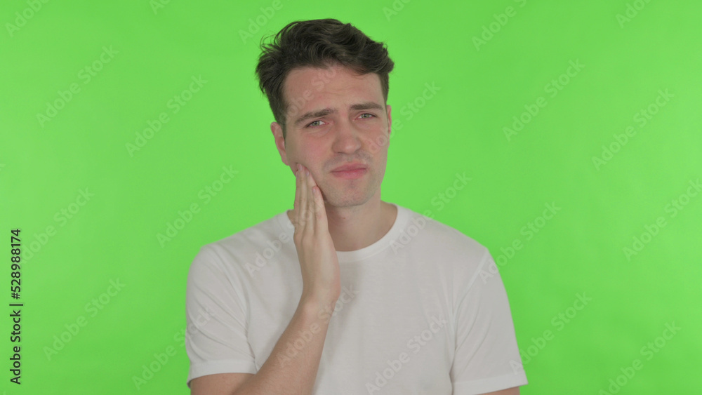 Young Man with Toothache on Green Background Young Man with Toothache on Green Background