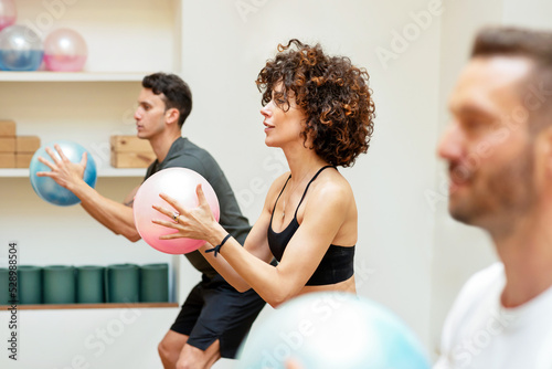 Men and woman exercising with fluiballs