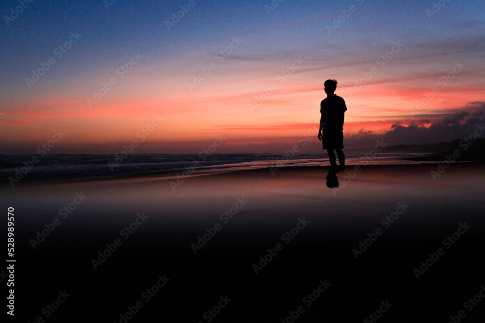 a male silhouette is standing a male silhouette is standing