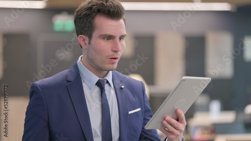 Portrait of Businessman having Loss on Tablet in Office