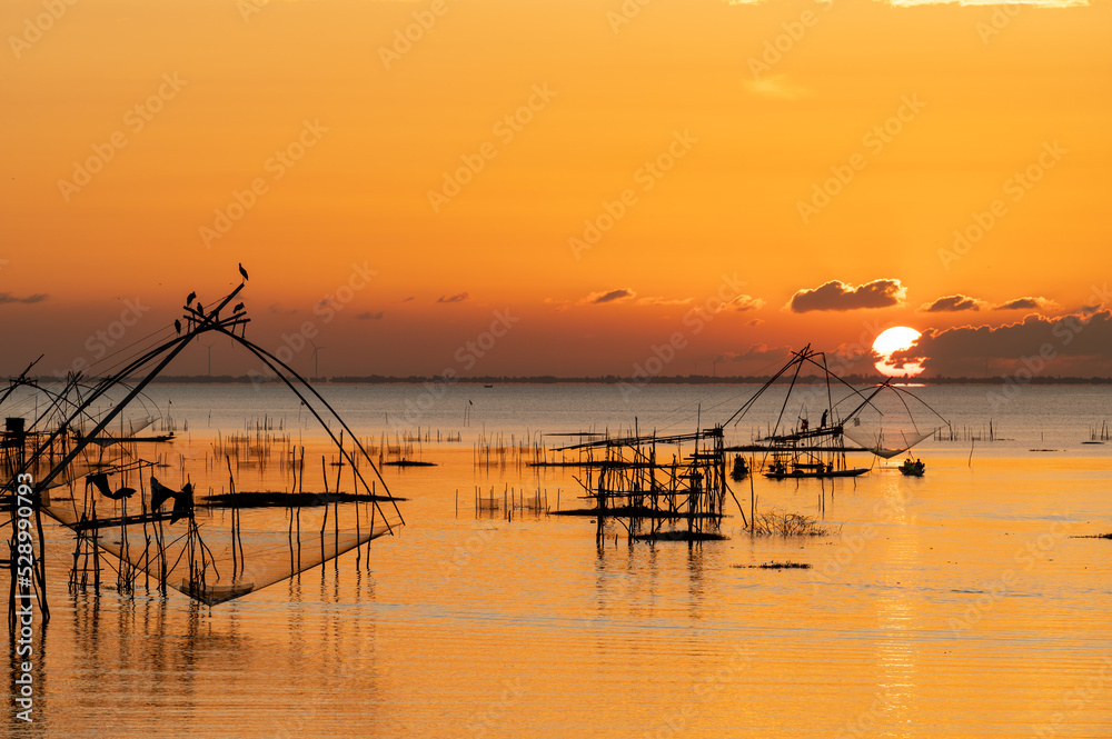 Square dip net in lake with sunrise at Pak pra village, Phatthalung, Thailand