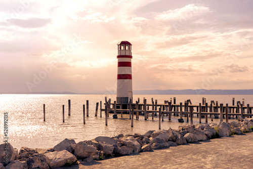 light house on pier in Podersdorf Austria next to Neusiedlersee at sunset photo