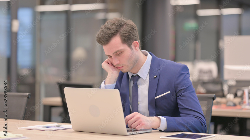 Tired Businessman taking Nap While Sitting in Office with Laptop Tired Businessman taking Nap While Sitting in Office with Laptop