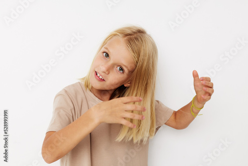 Portrait of a smiling little cutie hand gesture fun fashion on a light background