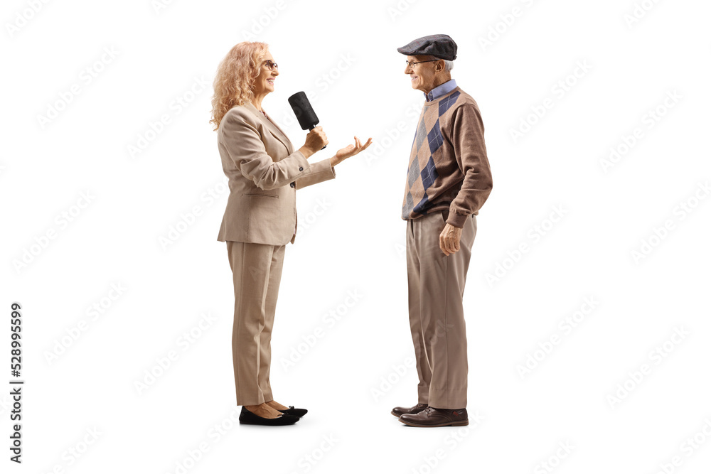 Female reporter interviewing an elderly man Female reporter interviewing an elderly man