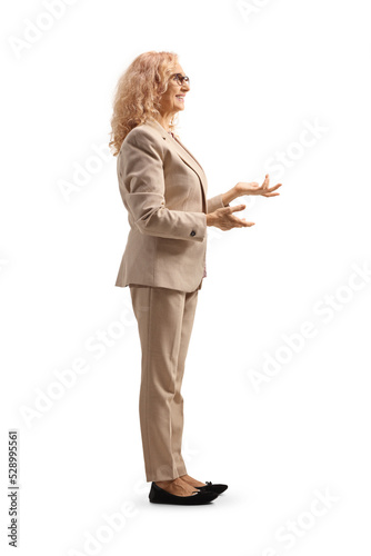 Full length profile shot of a professional woman talking