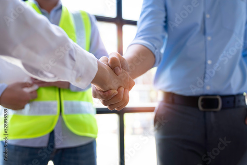 Architect shakes hands at meeting, meeting of two engineers or architects, shaking hands after discussion and meeting of new project plans, contracts for both companies, success, partnership
