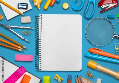 Set of various office supplies, paper clips, pins and white sheet of paper. Education, learning and creativity.