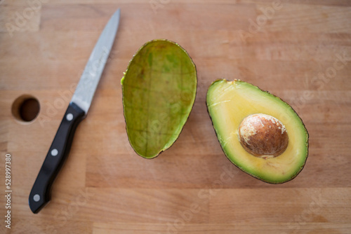 Half and peel of avocado photo