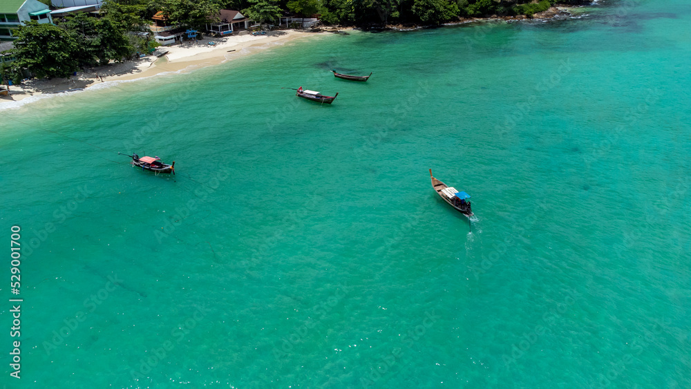 Fototapeta premium Photo in paradise island. Aerial photography of a boat in crystal clear waters. Phi Phi Island in Thailand. Paradise Beach. drone photography