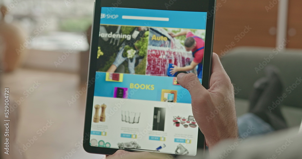 Closeup hands browsing online shopping website searching product to buy. Person sitting at home sofa scrolling through e-commerce site app Closeup hands browsing online shopping website searching product to buy. Person sitting at home sofa scrolling through e-commerce site app