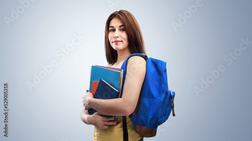 Young student girl posing on background