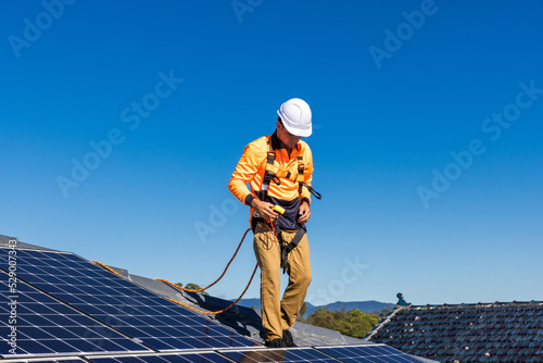 Solar panel technician with power meter and solar panels