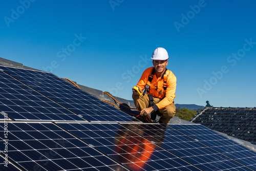 Solar panel technician with power meter and solar panels