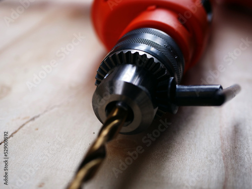 Electric power drill for diy on wooden background 