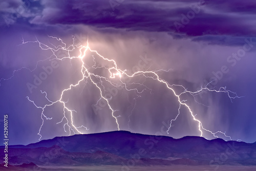 A lightning storm building behind Woodchute Mountain just east of Chino Valley Arizona during the 2022 Monsoon season.