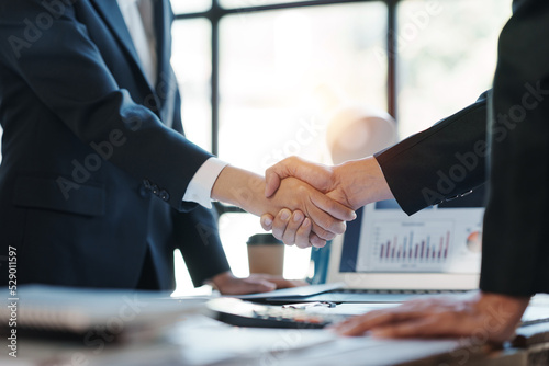 Business success. Business people shake hand to confirm the agreement to do business with joint investment in the company.