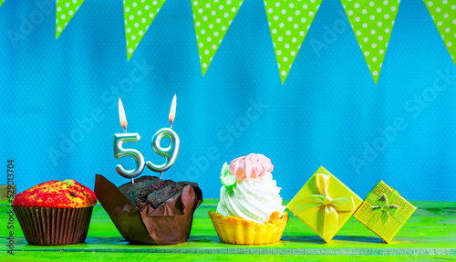 Happy birthday colorful background with decorations with festive garlands with pies and muffins and gift boxes with copy space. Beautiful happy birthday background with number 59 candles