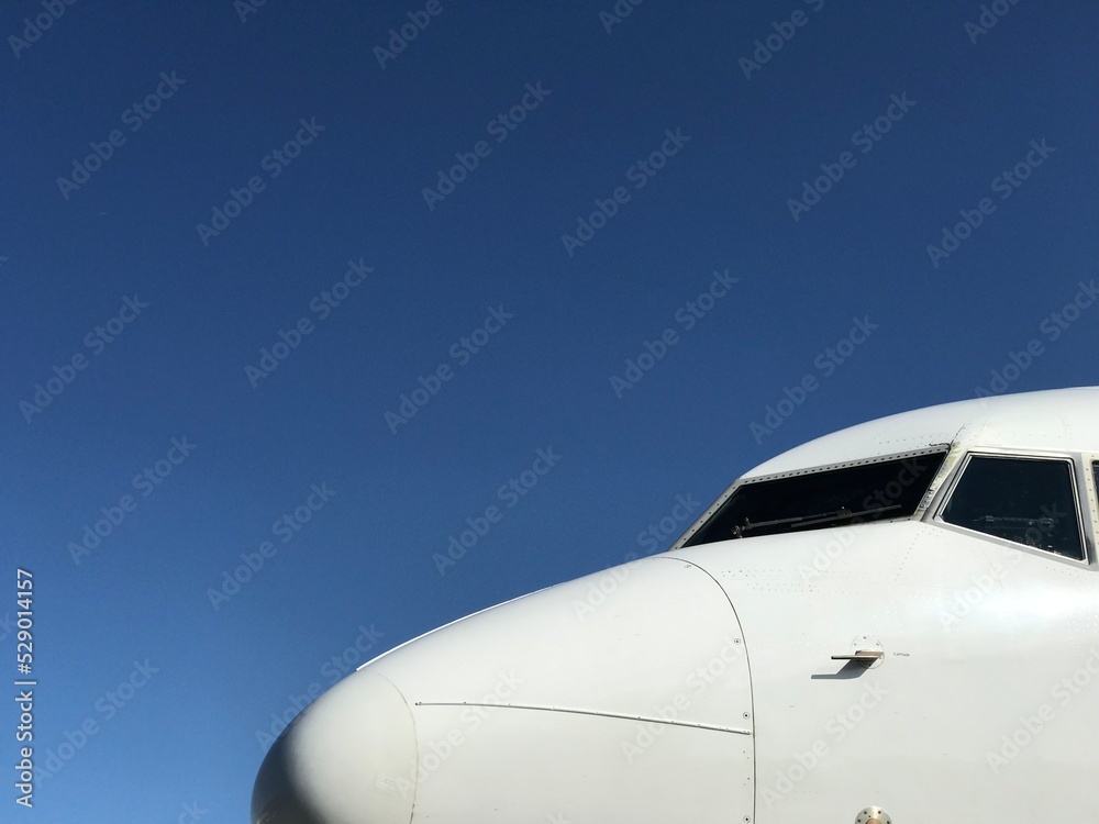 White Aeroplane Nose against clear Blue Sky 1