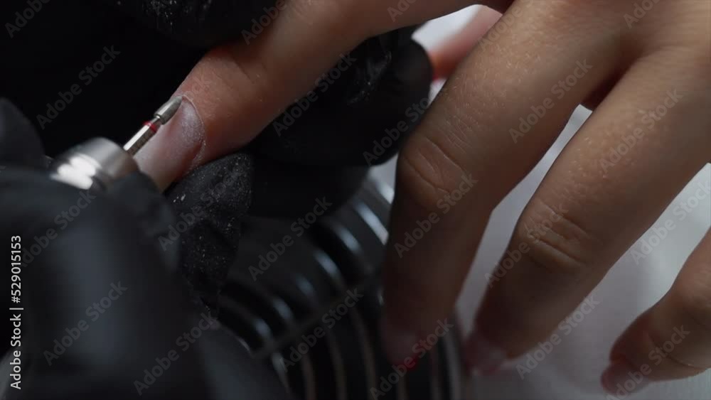 Manicurist master removing cuticles. 