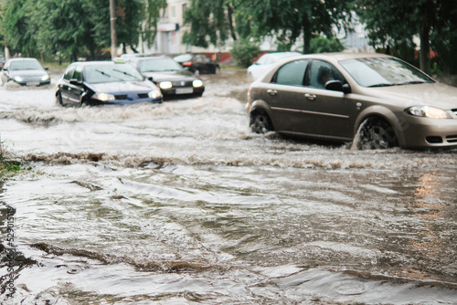 Cars on the street flooded with rain