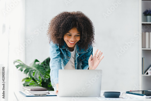 American woman chatting on laptop video call, she is an employee of the company, young people operations run the company with the concept of young people. Company management concept