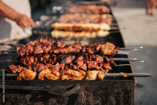 Roasting juicy meat steak with spices in burning charcoals fire on bbq grid