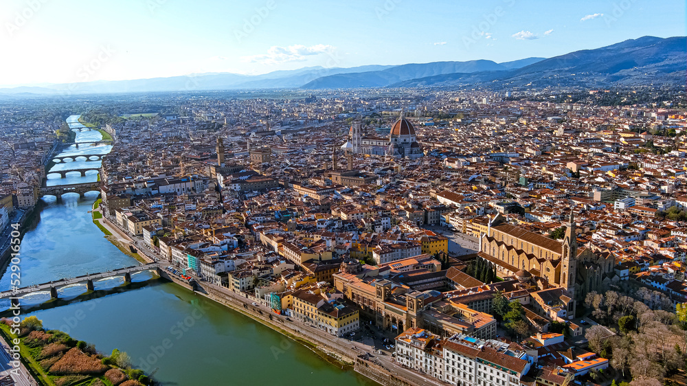 Florence, capital of Italy’s Tuscany region, is home of Renaissance art and architecture. Aerial view iconic sight Duomo Cathedral of Santa Maria del Fiore with beautiful city landscape and Arno River