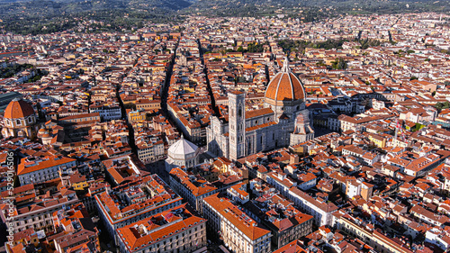 Fototapeta Naklejka Na Ścianę i Meble -  Cathedral of Santa Maria del Fiore aerial drone view in Florence, Italy.  Red-tiled dome, colored marble facade ft. elegant Giotto Tower around Piazza del Duomo square with iconic historic landmarks