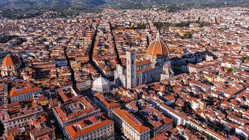Cathedral of Santa Maria del Fiore aerial drone view in Florence, Italy.  Red-tiled dome, colored marble facade ft. elegant Giotto Tower around Piazza del Duomo square with iconic historic landmarks photo