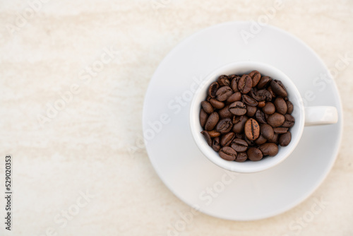 Coffee beans on a coffee cup, photo