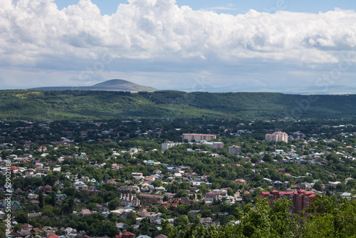 Panoramic top view of the city of Pyatigorsk Stavropol territory in a green valley and a mountain on the horizon on a sunny summer day and a space to copy