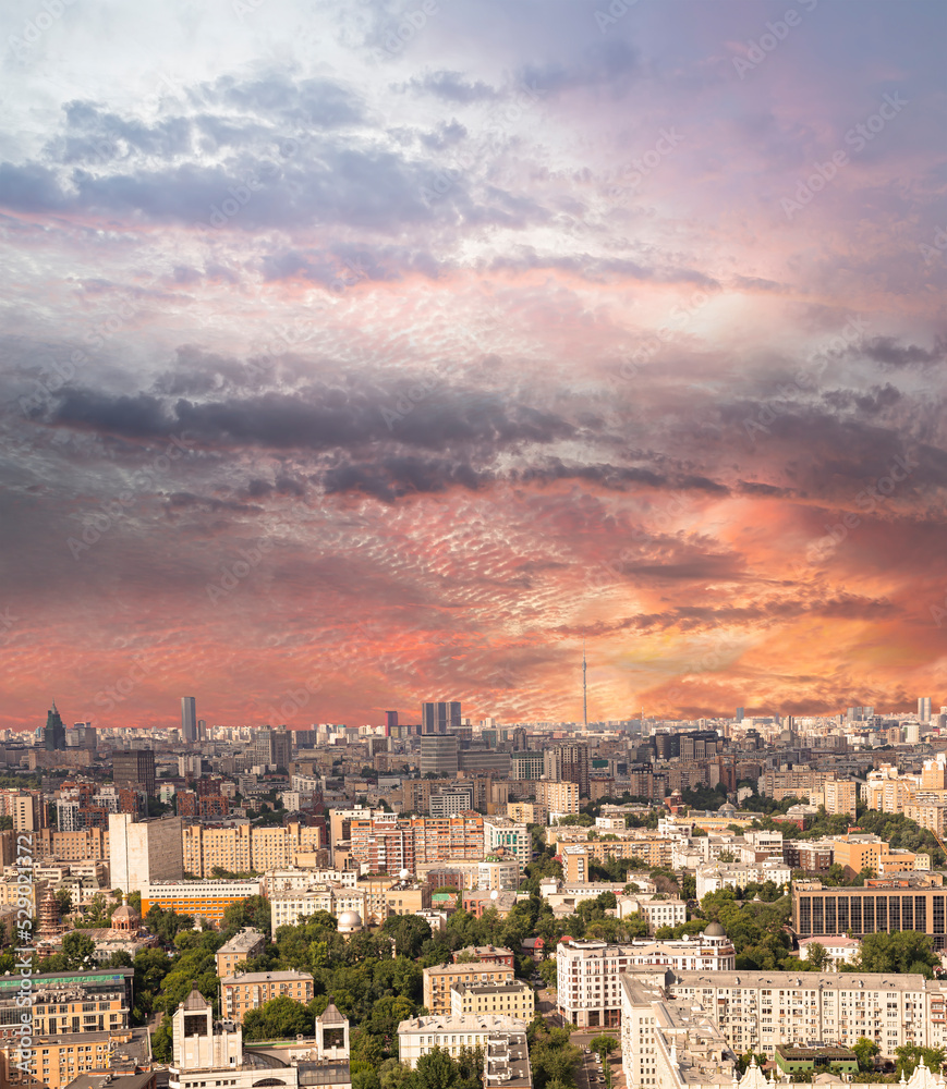 Aerial view of center of Moscow against the background of a romantic evening sky with clouds and rays of the sun, Russia