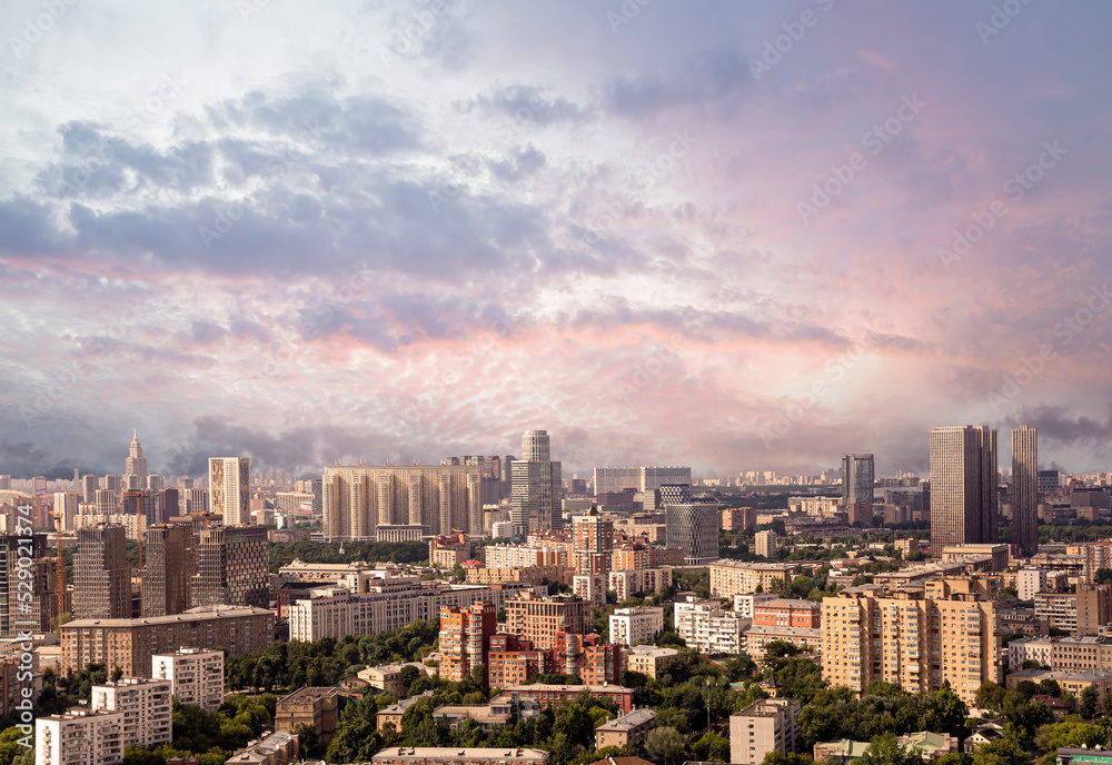 Aerial view of center of Moscow against the background of a romantic evening sky with clouds and rays of the sun, Russia