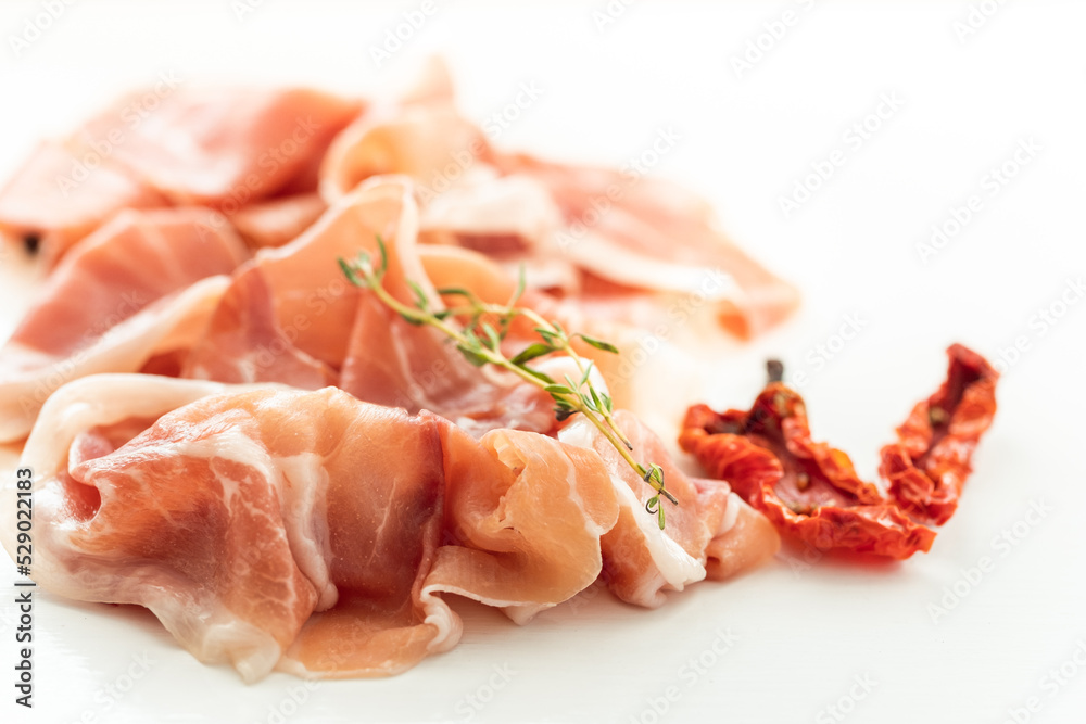 Slices of dried spanish ham. Jamon Serrano on the white background.
