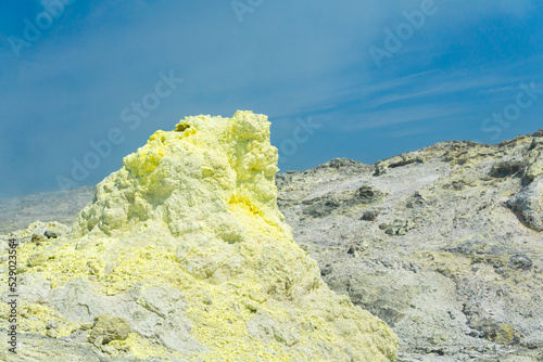 Obraz na plátně cone of sulfur deposits around a fumarole in a solfataric field against a blue s