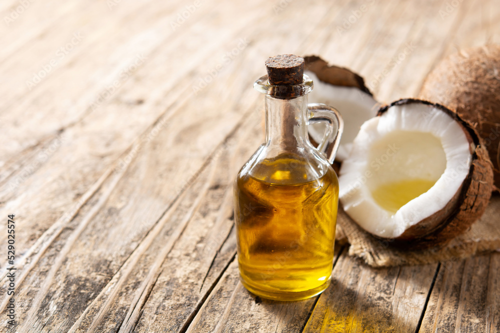 Coconut oil and bottle oil on wooden table. Copy space Coconut oil and bottle oil on wooden table. Copy space