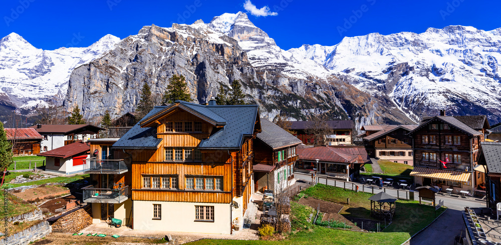 Switzerland nature and travel. Alpine scenery. Scenic traditional mountain village Murren surrounded by snow peaks of Alps. Popular tourist destination and ski resort