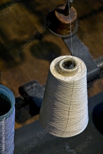 Spool of thread mounted in weaving loom at Boott Cotton Mill at Lowell National Historical Park photo