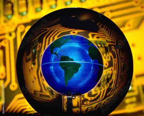 Globe superimposed over a circuit board photo