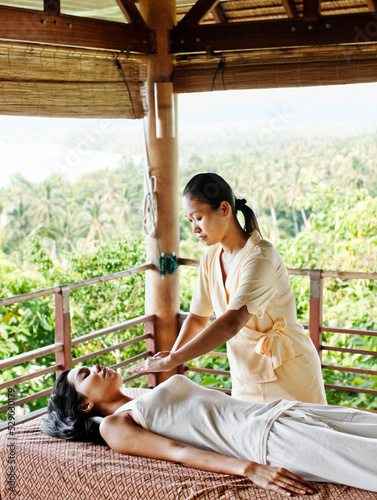 Therapist doing reiki at a spa. Koh Samui, Thailand.