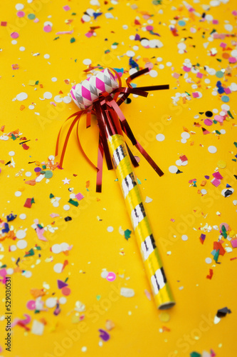 Close-up of a party horn blower and confetti photo