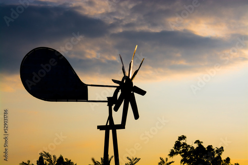 Tin pinwheel at late afternoon in windy weather