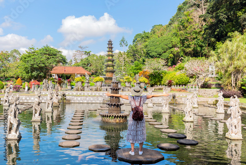 Tourist women wearing hat on holidays at Water Palace of Tirta Gangga in East Bali, Indonesia photo