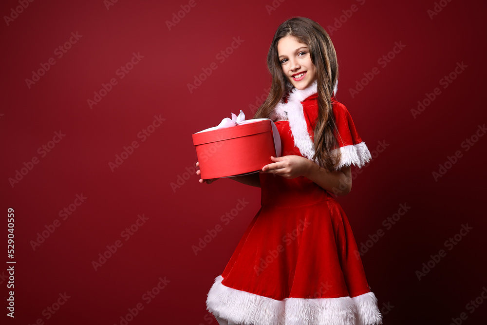 Beautiful little girl in festive costume hold gift box. christmas decoration. holiday. fun