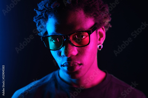  African American man portrait in sunglasses, isolated on purple background