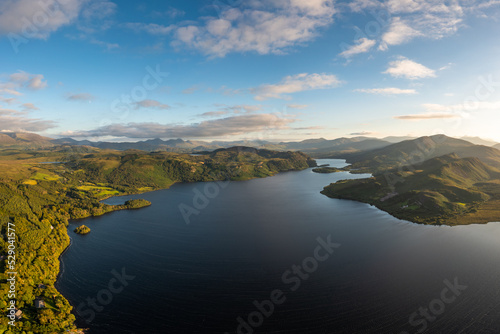 view of Lough Caragh lake in the Glencar Valley of Kerry County in warm eveing light