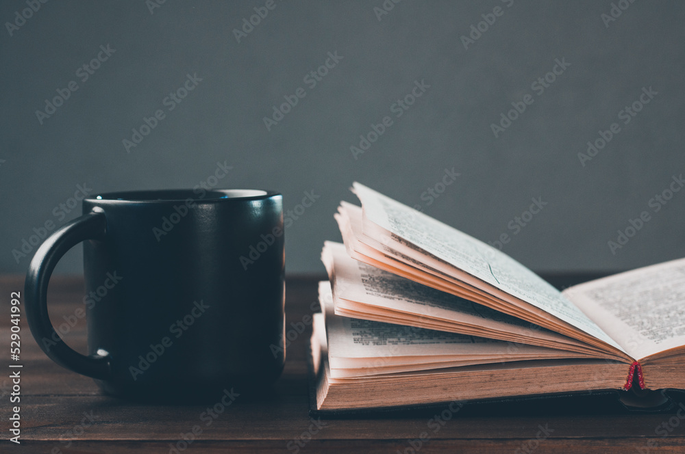 Naklejka premium Open bible pray. Holy bible book on the table. A cup. Prayer is praying.