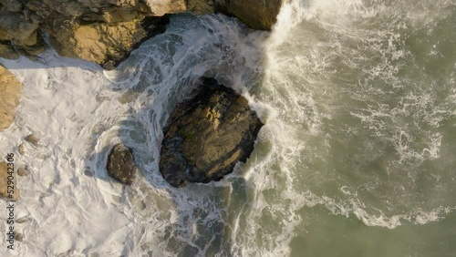 Beach and Cliffs with Waves Crashing into Rock - Ascend Spin Slow Motion